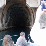 Submarine tunnel entrance with guests on a Good Hope Tours speed boat entering the tunnel and taking photos